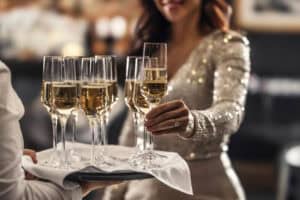 kobieta sięgająca po szampana na evencie premium